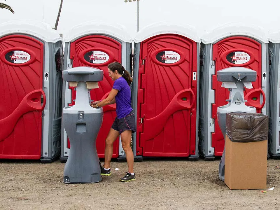 Standard toilets at a marathon, with hand wash station arranged in front