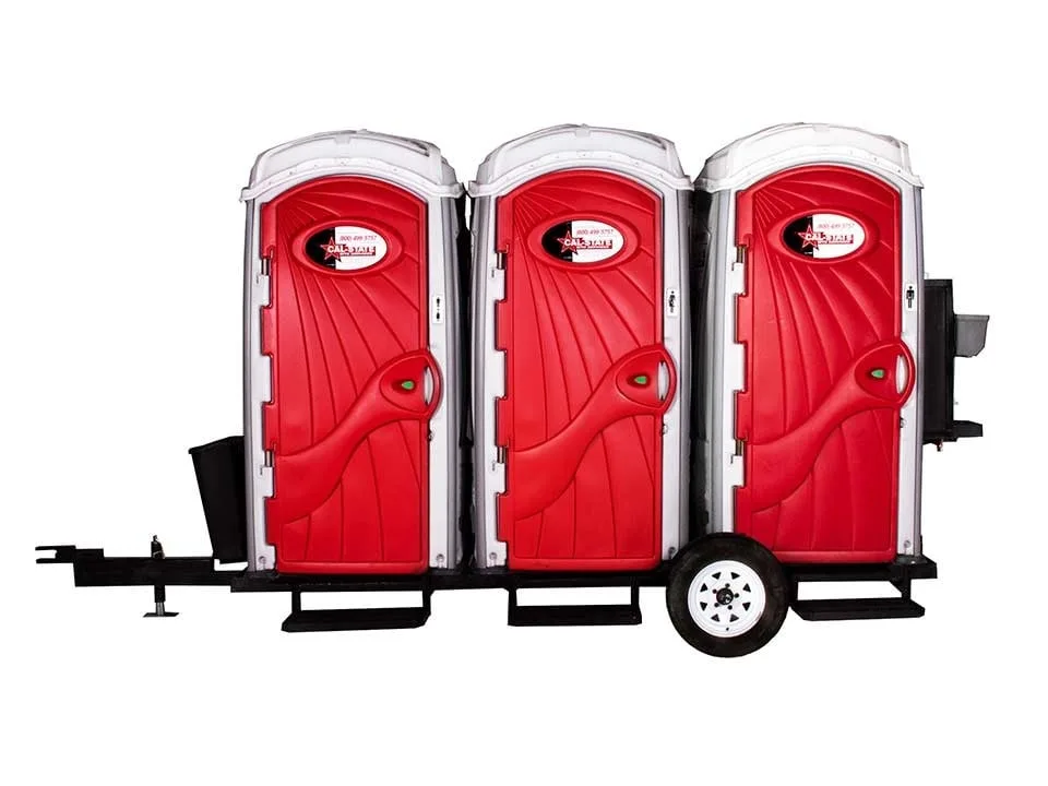 three standard toilet rentals mounted on trailer